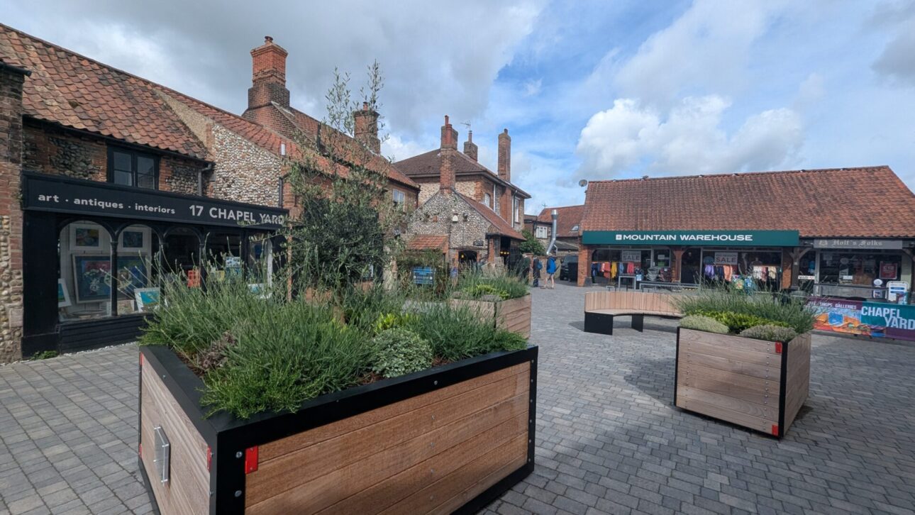 Chapel Yard shopping area with wooden planters in Holt Norfolk